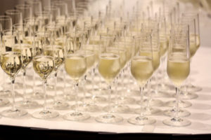 A table of glasses filled with champagne. 