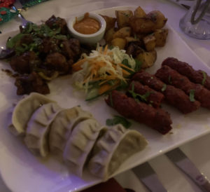 A sharing platter including dumplings and chicken