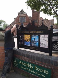 Acres' Engineer Liam, fitting the Melbourne Assembly Rooms notice board