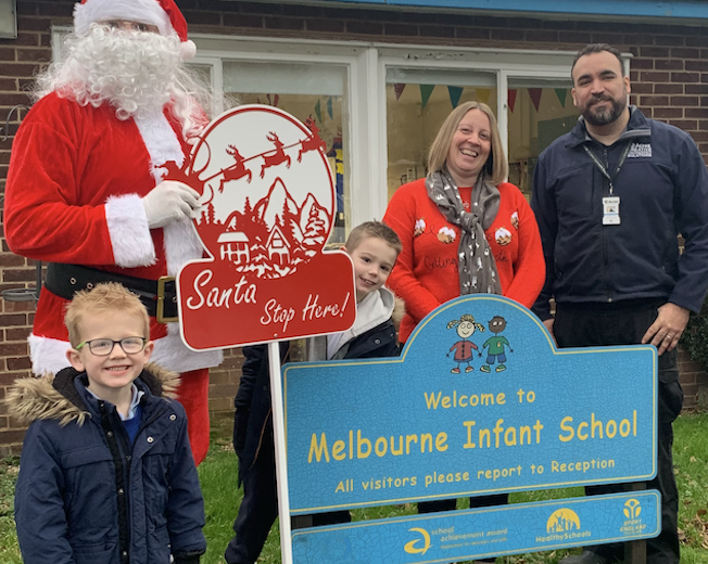 Santa Delivers Sign Donated by Acres to School